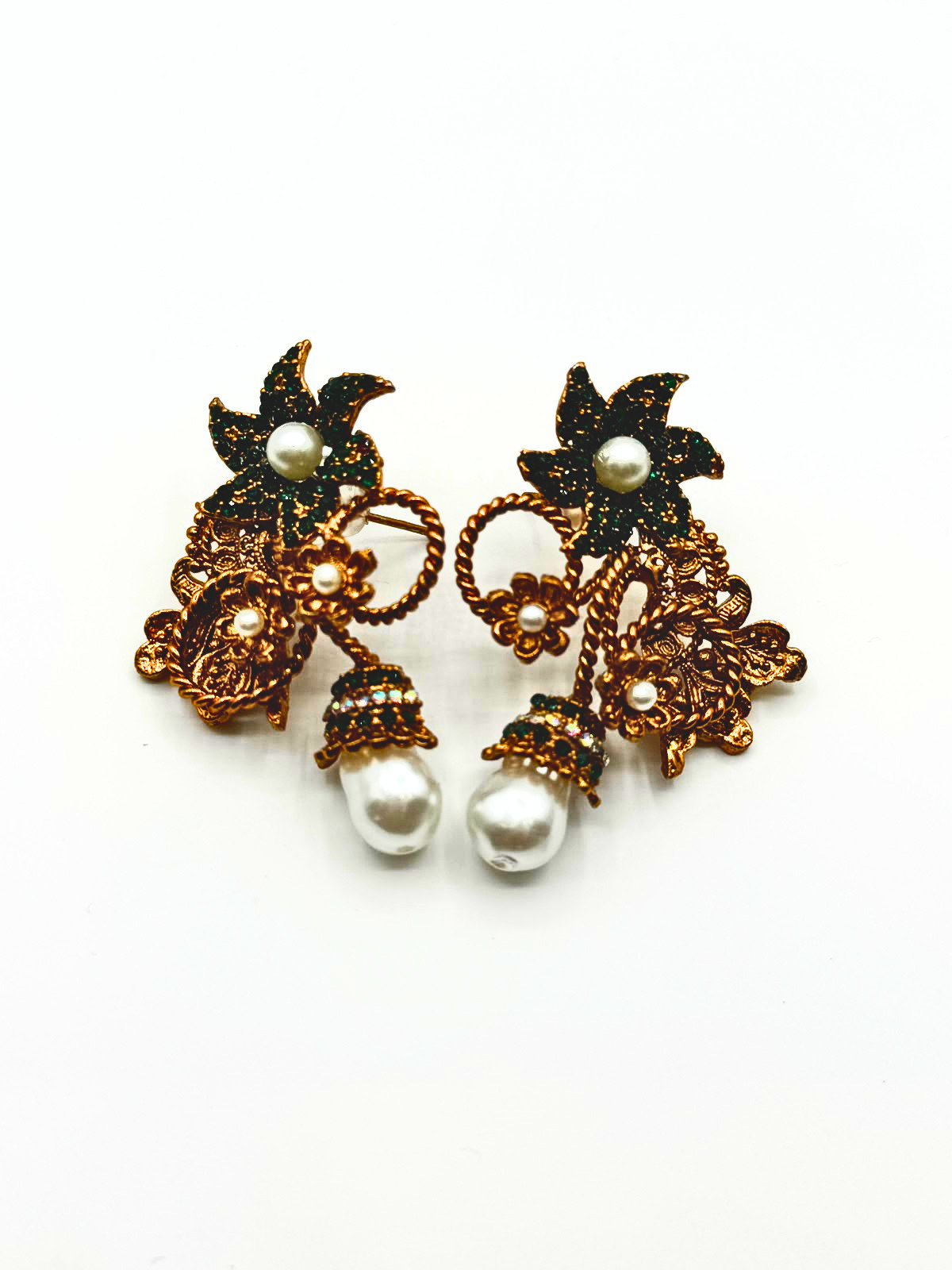 A pair of ornate gold and black floral drop earrings with white pearl accents, displayed on a clean white background.